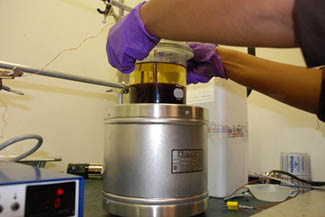 Technician inserting sample for Biomass Fractionation